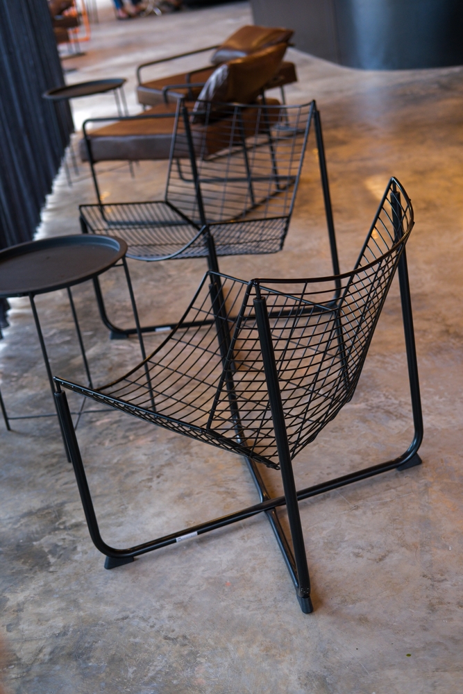 Modern,Minimalist,Industrial,Cafe,Interior,With,Black,Wireframe,Chairs,And