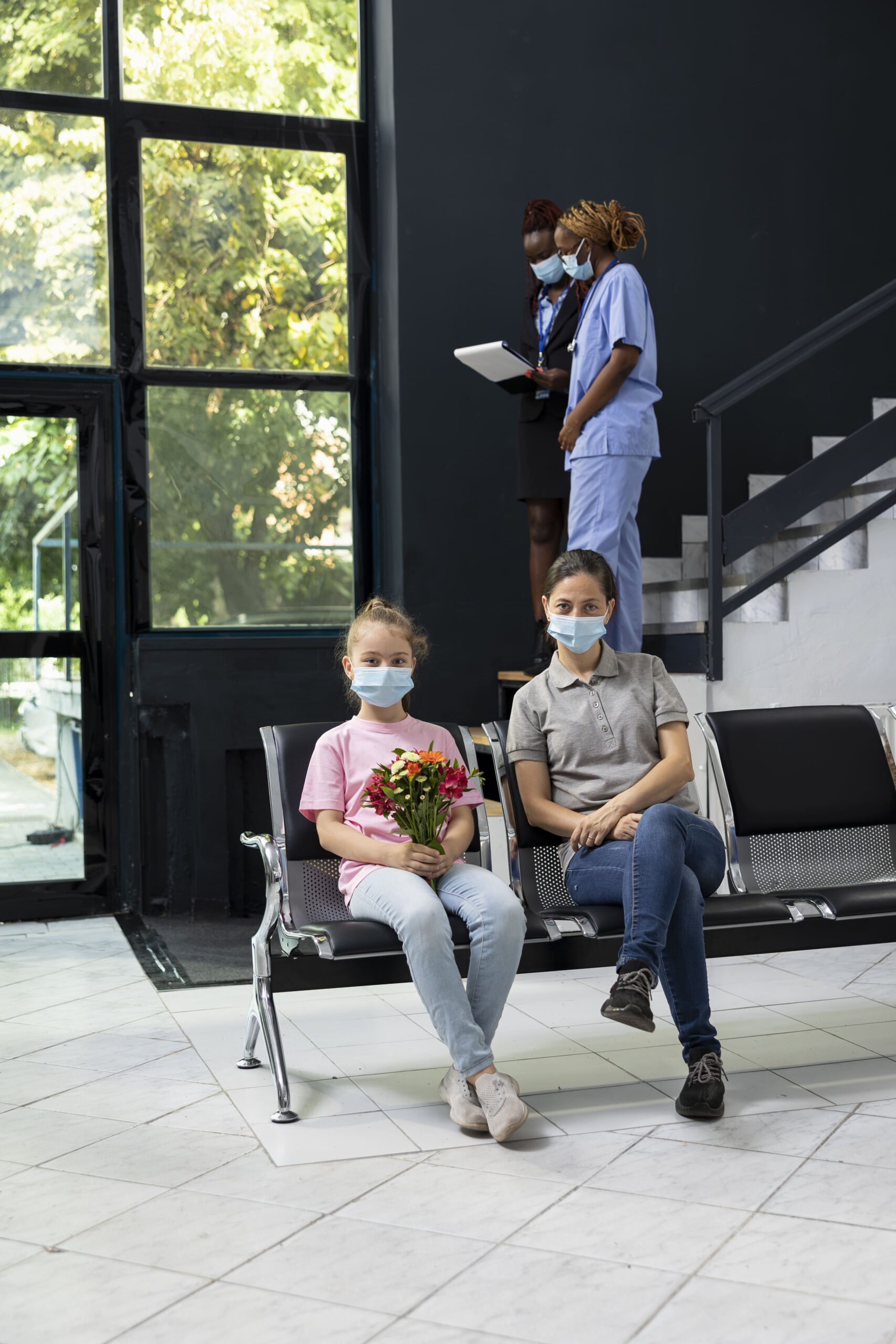 child mom sitting hospital lobby with flowers bouquet (1)